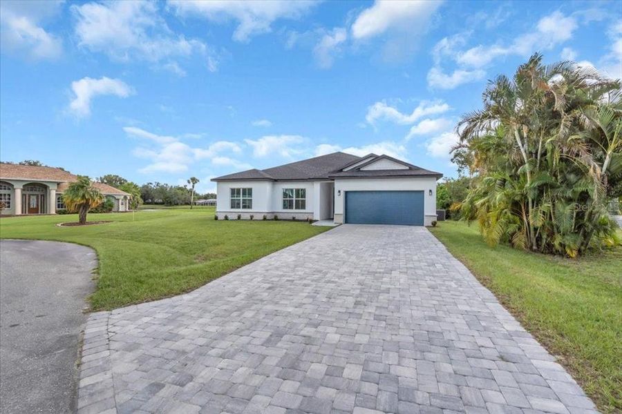 Front exterior of a new home in , Punta Gorda, FL, highlighting curb appeal (Image 2). Front exterior of a new home in , Punta Gorda, FL, highlighting curb appeal (Image 2).