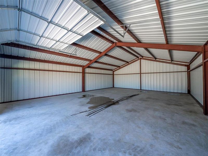 Prior listing photo. Property remains accurate - Garage with metal wall