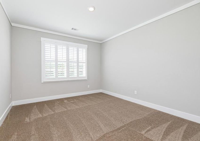 Secondary bedroom with carpet.