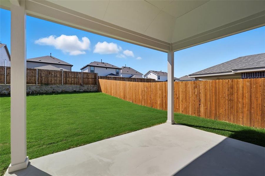 Fenced backyard with a patio and a residential view