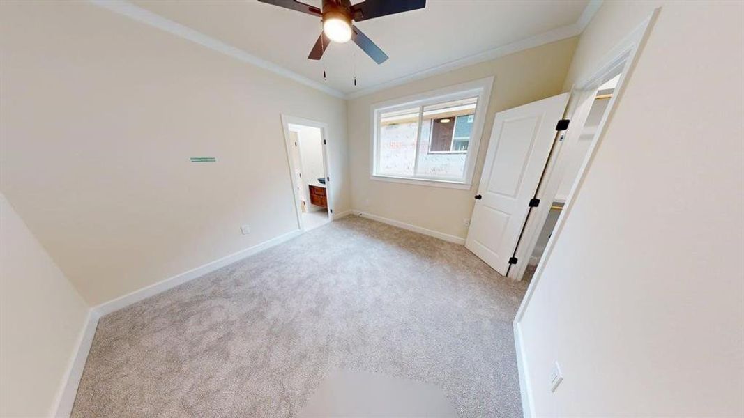 bedroom featuring carpet floors, crown molding, and a ceiling fan