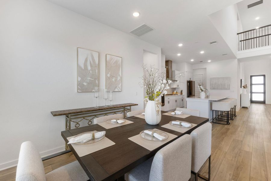 Dining area featuring recessed lighting, light wood-style floors, visible vents, and baseboards