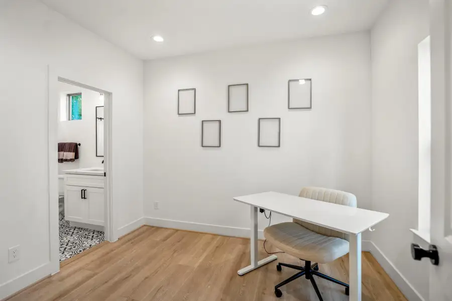 On the first floor, you’ll find a secondary bedroom complete with its own en-suite bathroom. Currently styled as a home office, this flexible space can effortlessly serve as a private guest suite—offering both convenience and privacy.