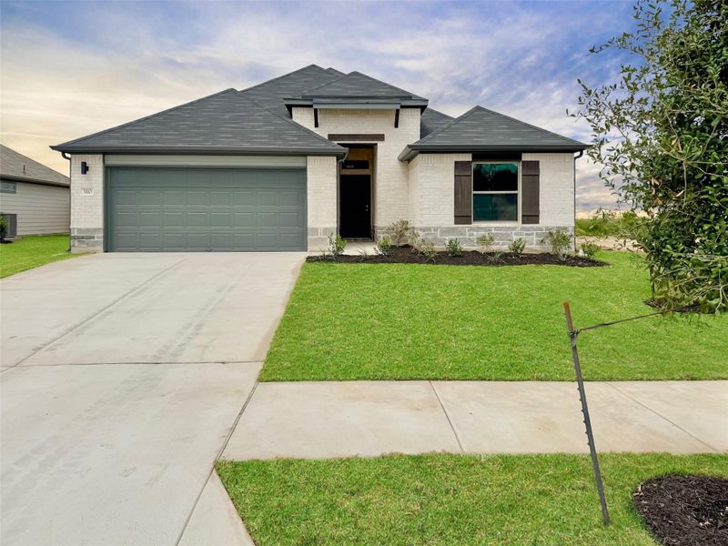 Front exterior of a new home in Prairie Winds, Hutto, TX, highlighting curb appeal (Image 1). Front exterior of a new home in Prairie Winds, Hutto, TX, highlighting curb appeal (Image 1).