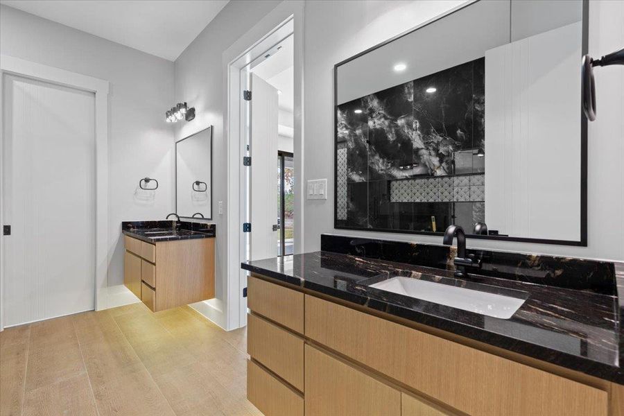 Primary full bathroom featuring separate vanities, ambient lighting Primary full bathroom featuring separate vanities, ambient lighting