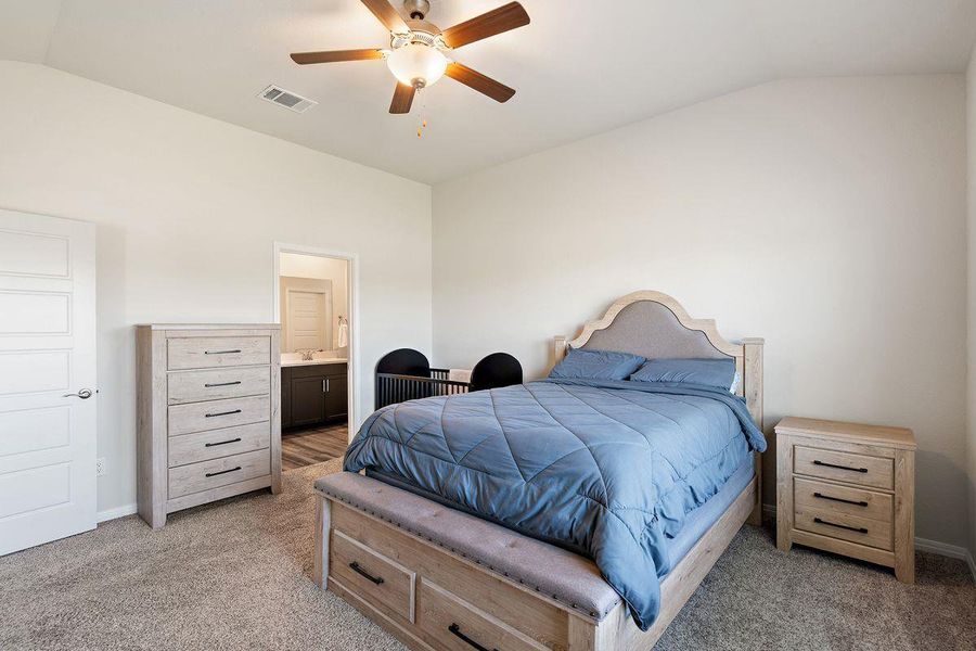 Primary suite featuring a walk-in closet and private bath access, with room for a sitting area or crib. Primary suite featuring a walk-in closet and private bath access, with room for a sitting area or crib.