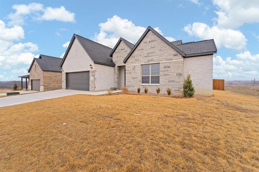 Front exterior of a new home in , Venus, TX, highlighting curb appeal (Image 19).