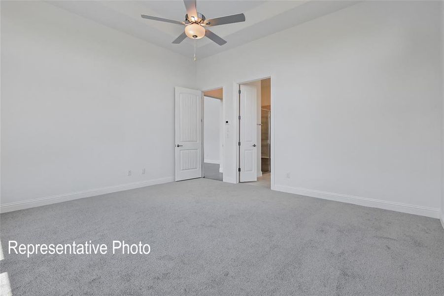 Carpeted spare room with ceiling fan