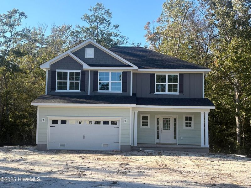 Front exterior of a new home in Rutledge, Shallotte, NC, highlighting curb appeal (Image 1).