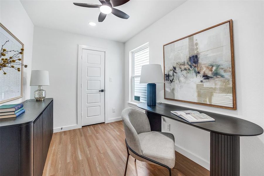 Office area featuring light wood-style flooring and a ceiling fan Office area featuring light wood-style flooring and a ceiling fan