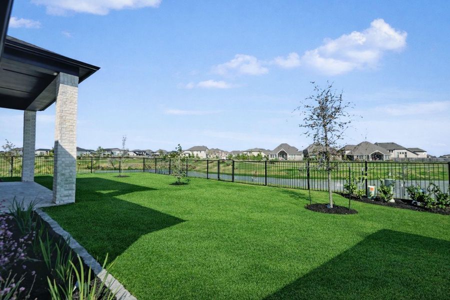 Spacious backyard with covered patio, green space, and no rear neighbors—ideal for outdoor living and entertaining.