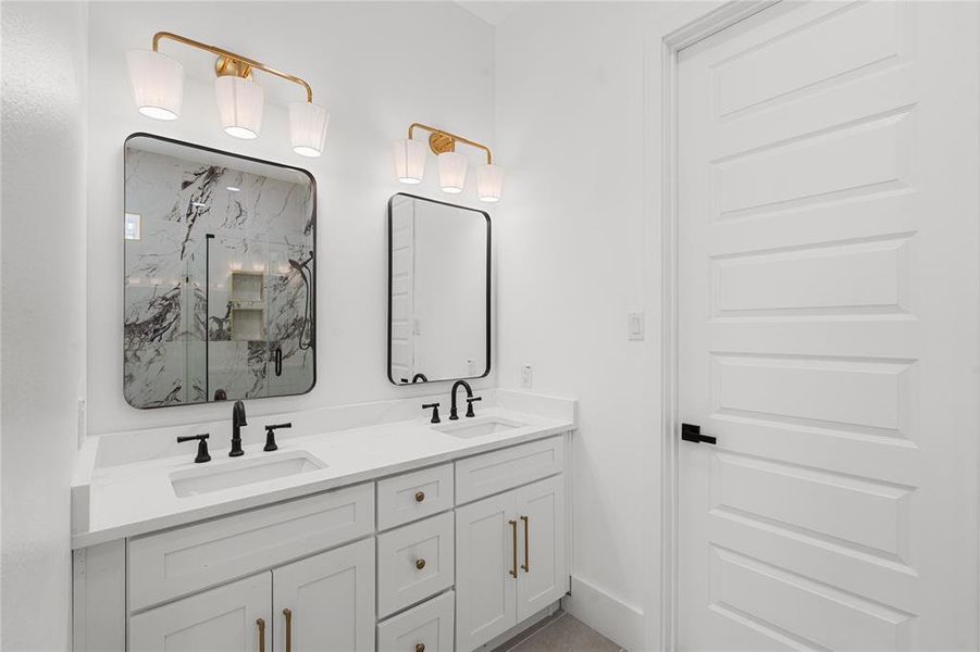 Bathroom with double vanity and a marble finish shower Bathroom with double vanity and a marble finish shower