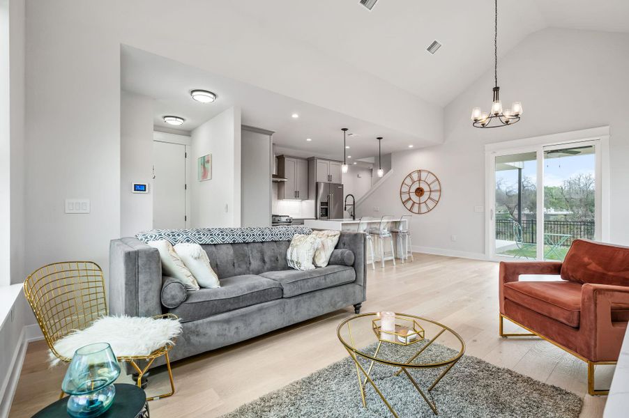 Living area with light wood flooring,  vaulted ceiling
