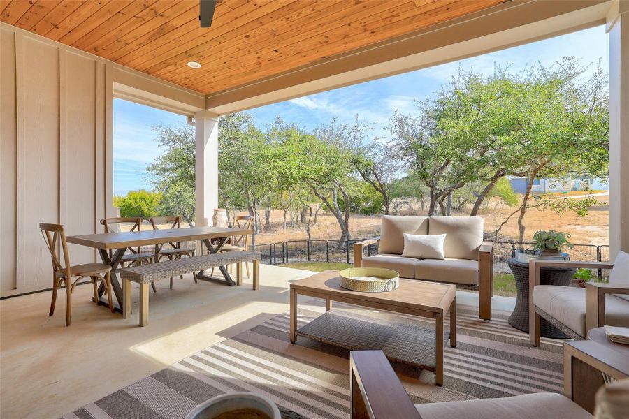 Covered back patio with wood plank ceiling, ceiling fan and recessed lights