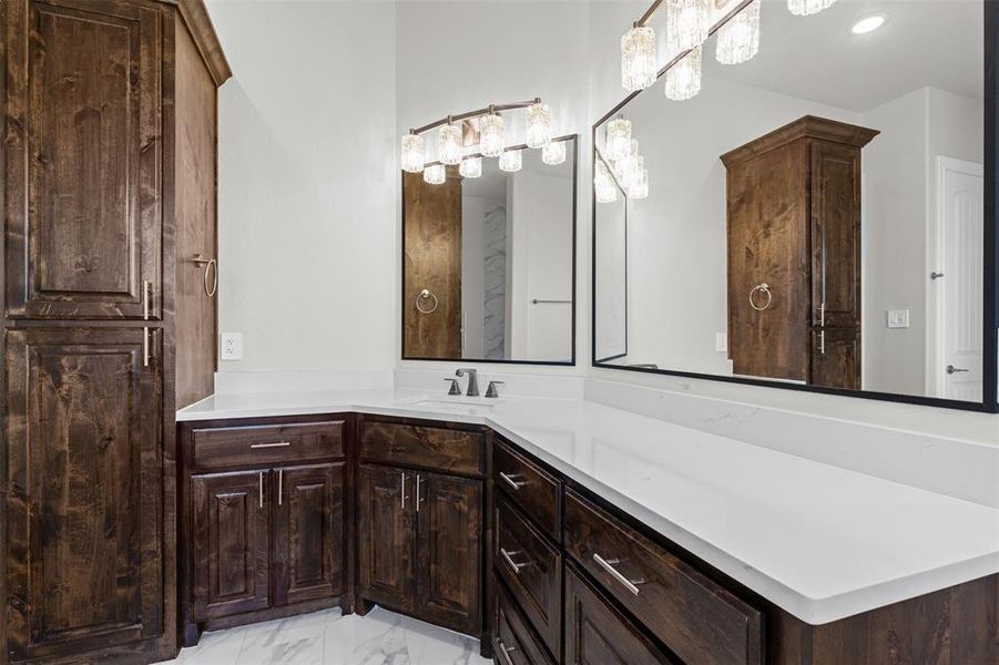 Primary Bathroom featuring vanity and light marble finish floors Primary Bathroom featuring vanity and light marble finish floors