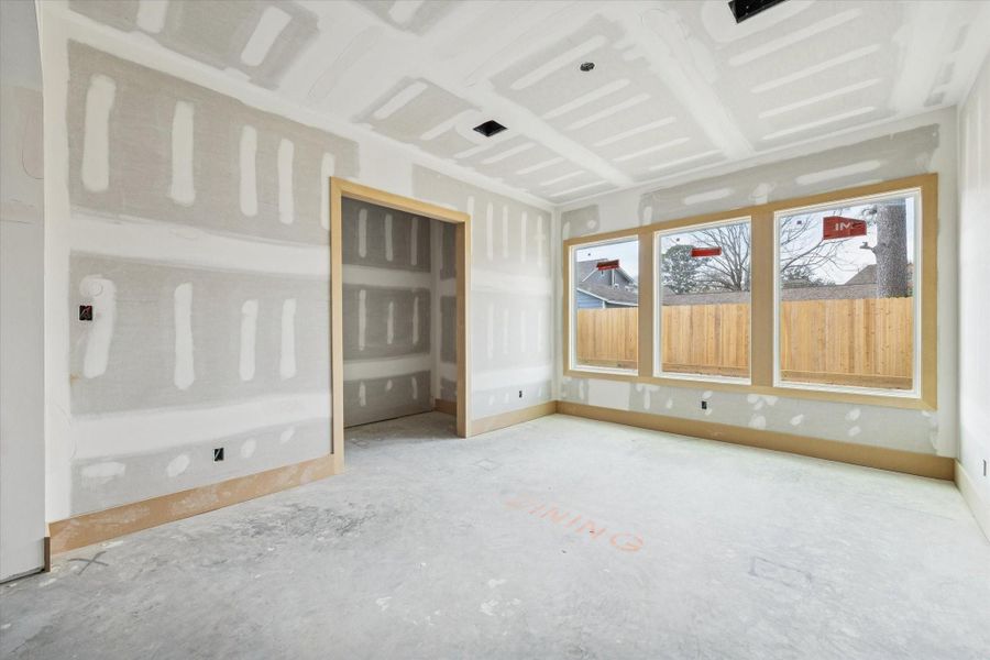 Dedicated dining space framed by oversized rear windows and designed to showcase a statement wine wall. Positioned just off the kitchen for seamless entertaining, with easy flow to the covered patio for indoor outdoor gatherings.