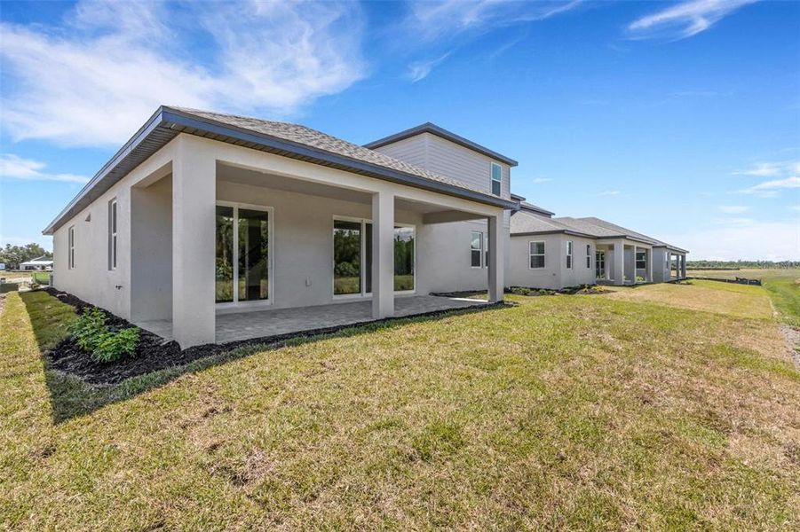 Exterior details and patio area of a home in Creeks Edge at Twin Rivers, Parrish (Image 26).