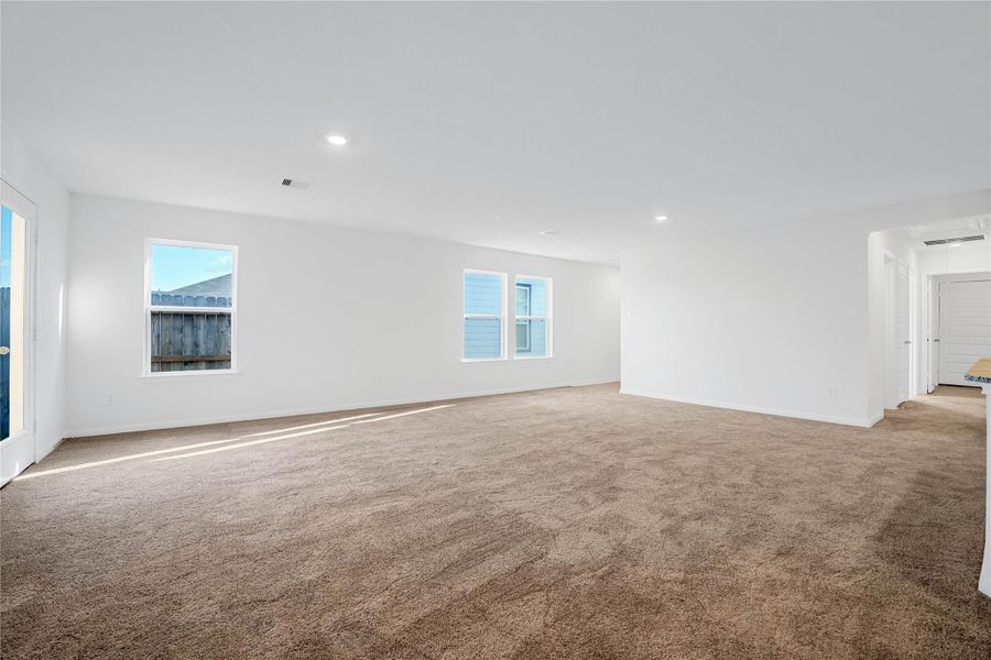 This bright and airy Great Room offers a spacious layout ideal for both relaxing evenings and lively gatherings. Designed for comfort and connection, it features plus carpet flooring, large windows, high ceilings, recessed lighting, and seamless access to the stunning kitchen—perfect for everyday living and entertaining alike. This bright and airy Great Room offers a spacious layout ideal for both relaxing evenings and lively gatherings. Designed for comfort and connection, it features plus carpet flooring, large windows, high ceilings, recessed lighting, and seamless access to the stunning kitchen—perfect for everyday living and entertaining alike.