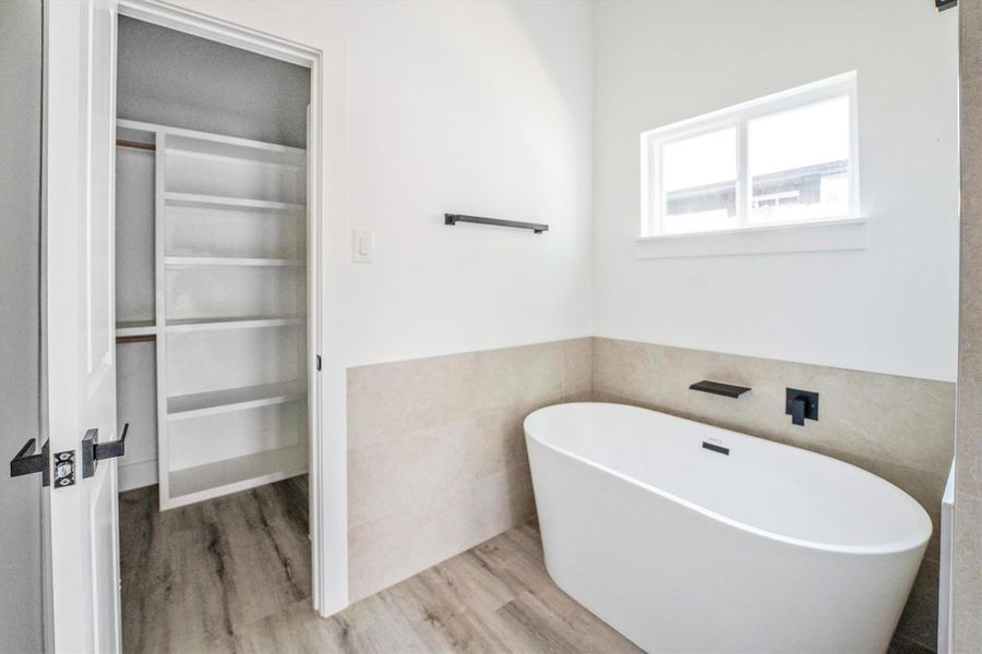 Discover ultimate relaxation in the primary bathroom with elegant double sinks, a luxurious soaking tub, and a serene stand-up shower.