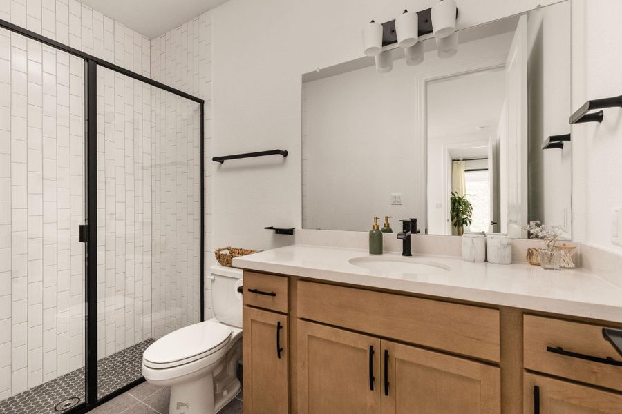 MIL suitebath room with tiled walk-in shower.