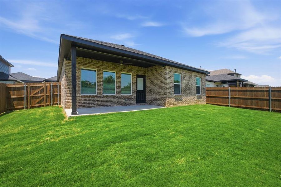 Brick exterior with a covered patio and concrete slab