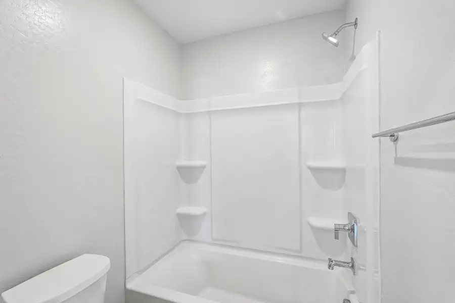 A bathroom with a tub toilet and sink.