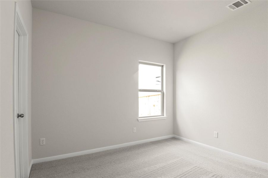 Spare room with light colored carpet and baseboards