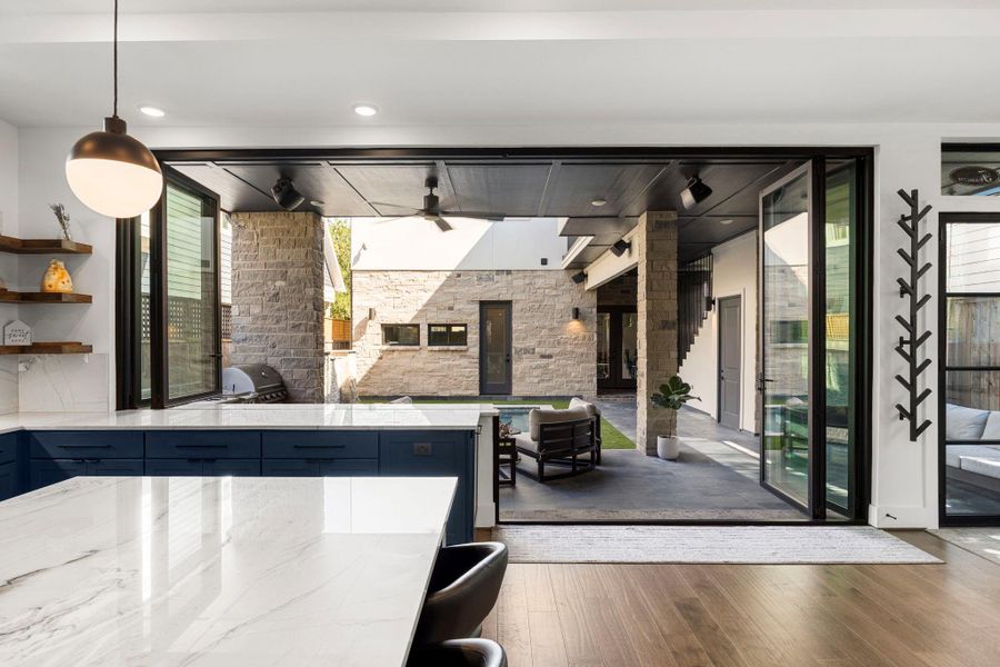 From the main house, take in the backyard view featuring gunite pool, back of 3-car garage, and a full bathroom accessible directly from the pool area.