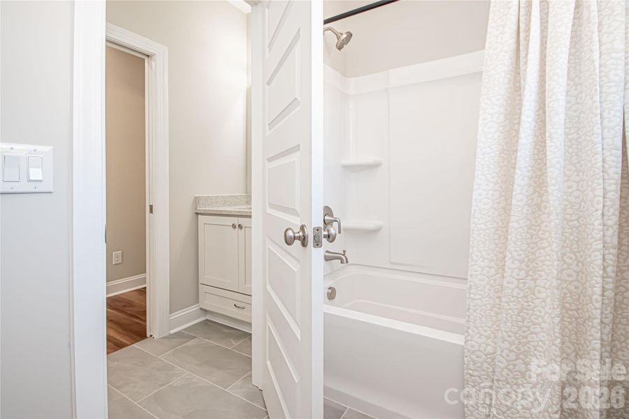 The hall bathroom is designed with a separate toilet and shower area apart from the vanities, providing added convenience for multiple users.