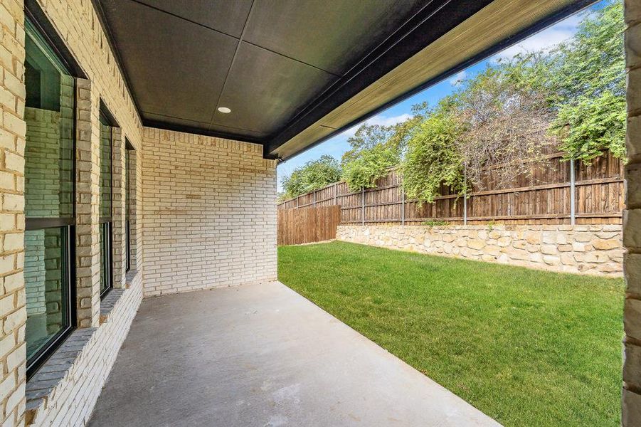 Fenced backyard featuring a patio