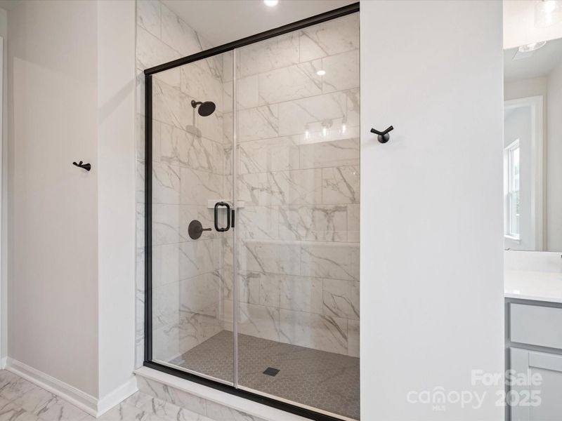 Walk-In Tile Surround Shower at Primary Bath.  *Model Photos | Actual Finishes, Structural Selections, and Orientation May Vary.
