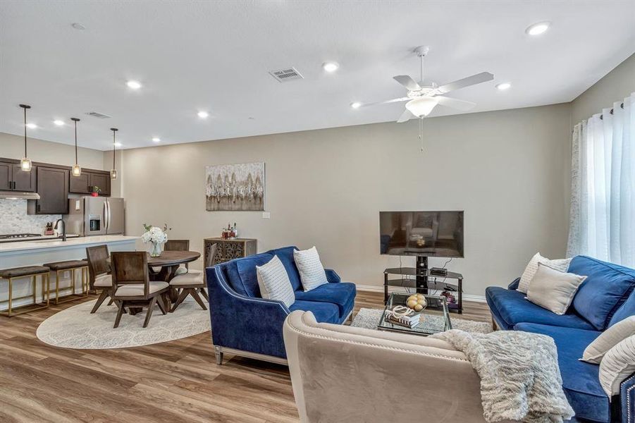 Living room with ceiling fan, hardwood / wood-style flooring, and sink