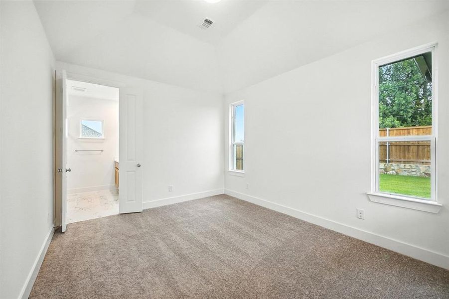 Unfurnished bedroom with carpet and baseboards Unfurnished bedroom with carpet and baseboards