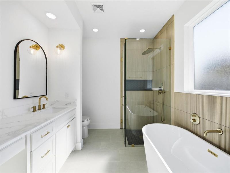 Bathroom featuring a soaking tub, a shower stall, vanity, light tile patterned floors, and recessed lighting