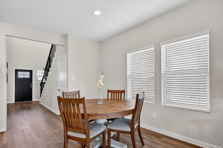Dining space with dark wood-style floors and recessed lighting