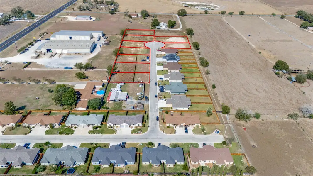 Aerial view of sparsely populated area featuring property boundaries highlighted