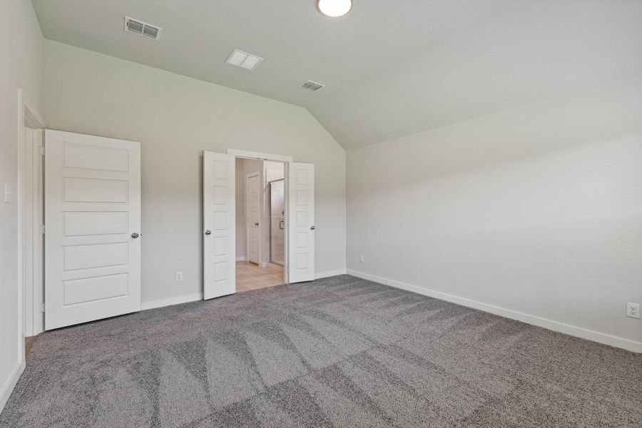 Primary bedroom in the Quartz home plan by Trophy Signature Homes – REPRESENTATIVE PHOTO
