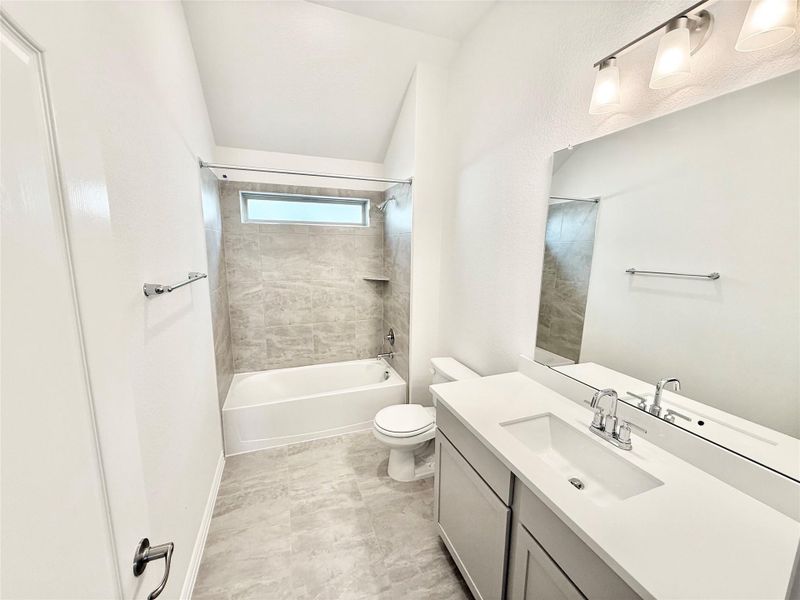 Full bath featuring vanity and washtub / shower combination