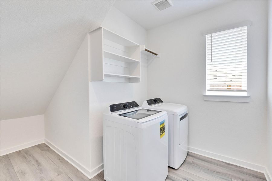 Laundry room featuring light wood-type flooring and washing machine and dryer Laundry room featuring light wood-type flooring and washing machine and dryer