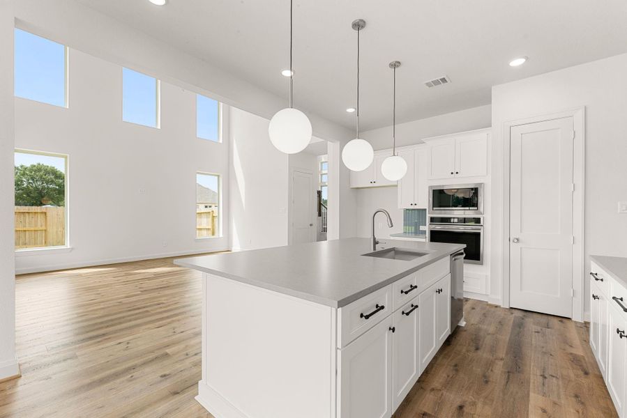 The kitchen opens directly onto the great room and a set of glass doors leading to the backyard, keeping indoor and outdoor living within a few steps of each other. The kitchen opens directly onto the great room and a set of glass doors leading to the backyard, keeping indoor and outdoor living within a few steps of each other.