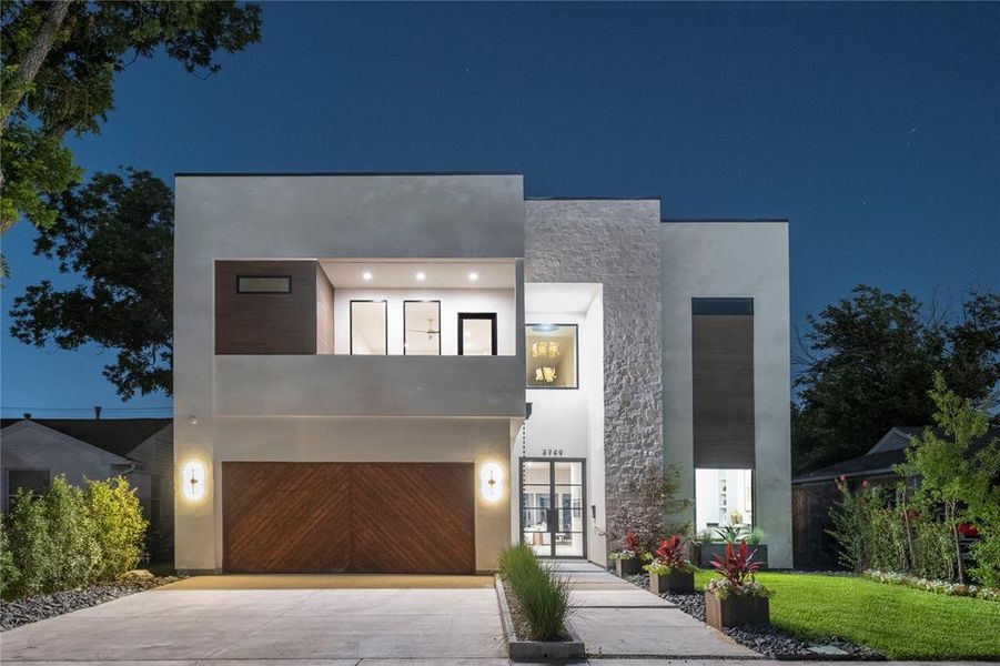 Contemporary home featuring a garage and a balcony