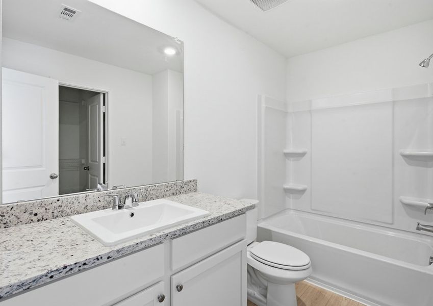 Ensuite bathroom connected to Bedroom 5 featuring a vanity with granite countertop and a tub/shower combination. Ensuite bathroom connected to Bedroom 5 featuring a vanity with granite countertop and a tub/shower combination.