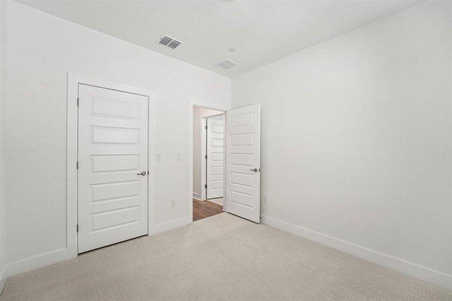 There are two secondary bedrooms on the upper level, one with its own ensuite. (Sample photo of finishes and layout)