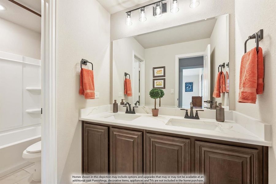 Bathroom with double sink vanity, dark wood cabinets, white quartz countertop, large mirror, and walk-in shower with toilet visible Bathroom with double sink vanity, dark wood cabinets, white quartz countertop, large mirror, and walk-in shower with toilet visible