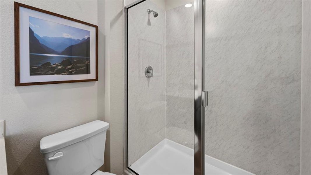 Full bath with a shower stall and toilet