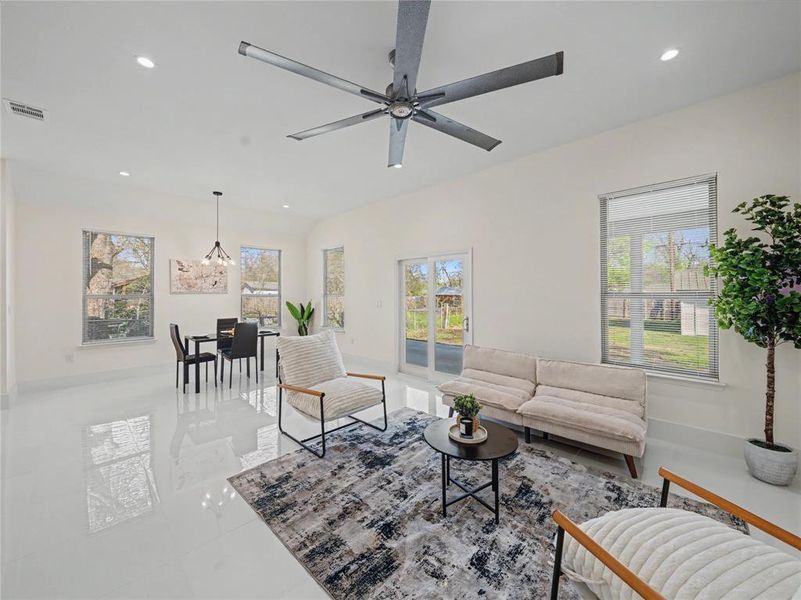 Living room featuring a ceiling fan and hanging lights
