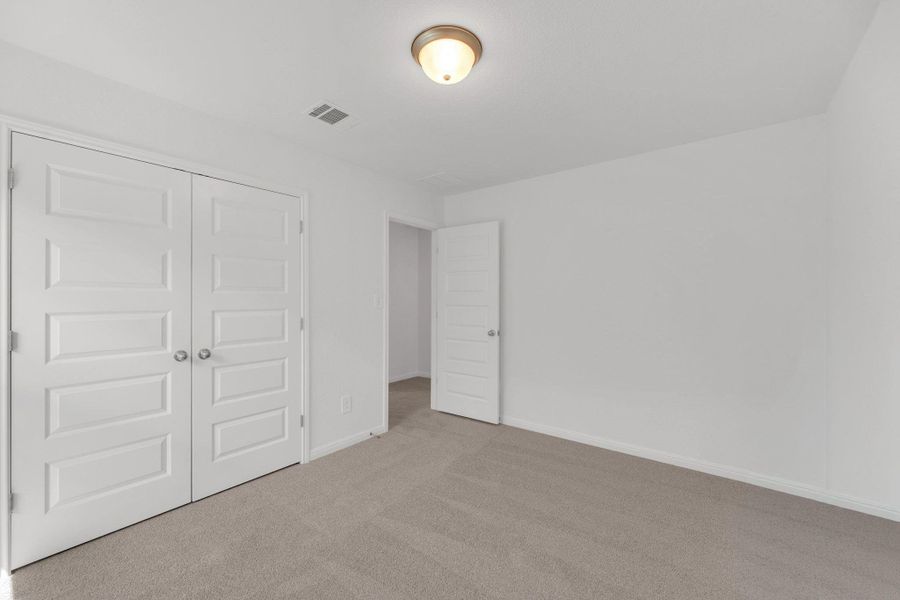 Unfurnished bedroom featuring carpet flooring and a closet Unfurnished bedroom featuring carpet flooring and a closet