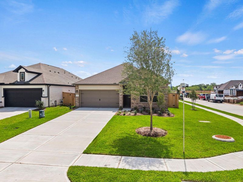 Front exterior of a new home in Windrose Green, Angleton, TX, highlighting curb appeal (Image 20). Front exterior of a new home in Windrose Green, Angleton, TX, highlighting curb appeal (Image 20).