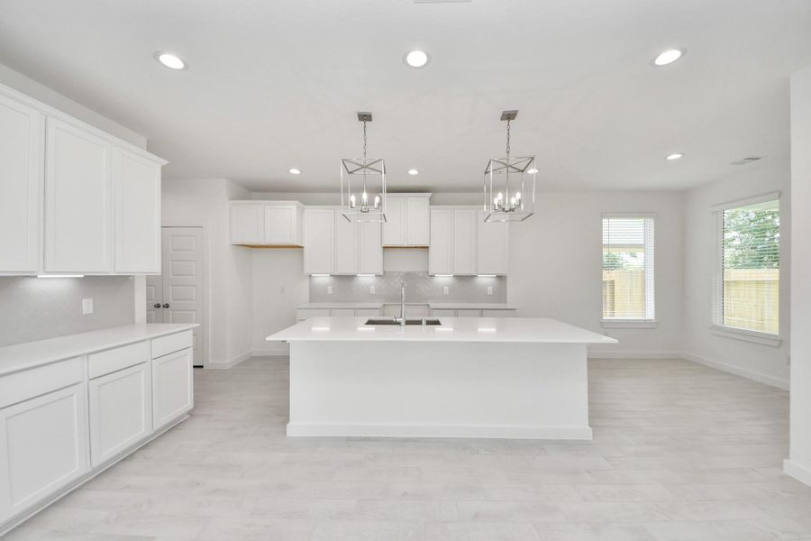 This kitchen is by far any chef’s dream! This spacious kitchen features high ceilings, light stained wood cabinets, granite countertop, SS appliances, modern tile backsplash, recessed lighting, extended counter space, granite kitchen island, and space for breakfast bar, and a walk-in pantry all overlooking your huge family room. This kitchen is by far any chef’s dream! This spacious kitchen features high ceilings, light stained wood cabinets, granite countertop, SS appliances, modern tile backsplash, recessed lighting, extended counter space, granite kitchen island, and space for breakfast bar, and a walk-in pantry all overlooking your huge family room.