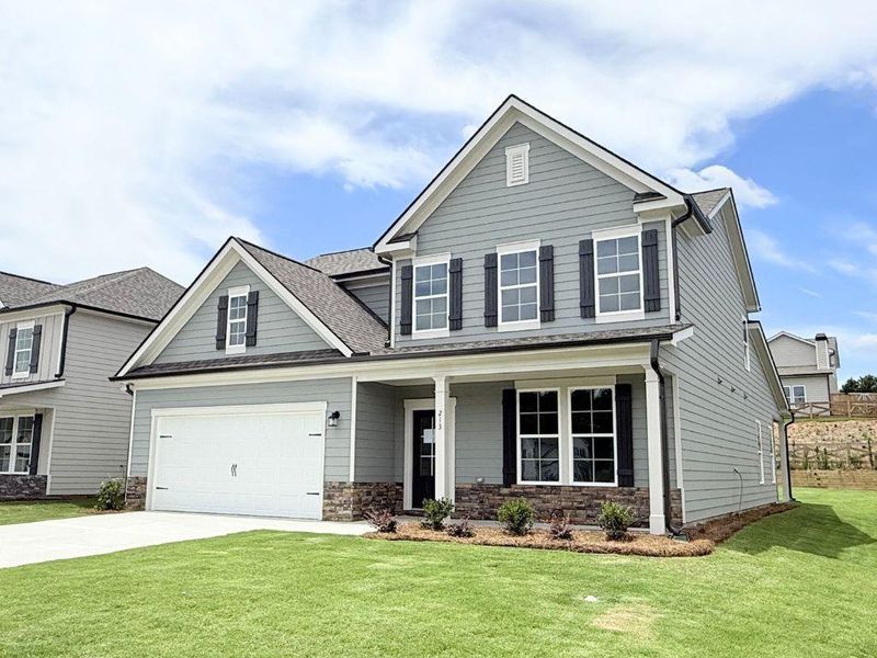 Front exterior of a new home in Sutton’s Landing, Statham, GA, highlighting curb appeal (Image 1). Front exterior of a new home in Sutton’s Landing, Statham, GA, highlighting curb appeal (Image 1).